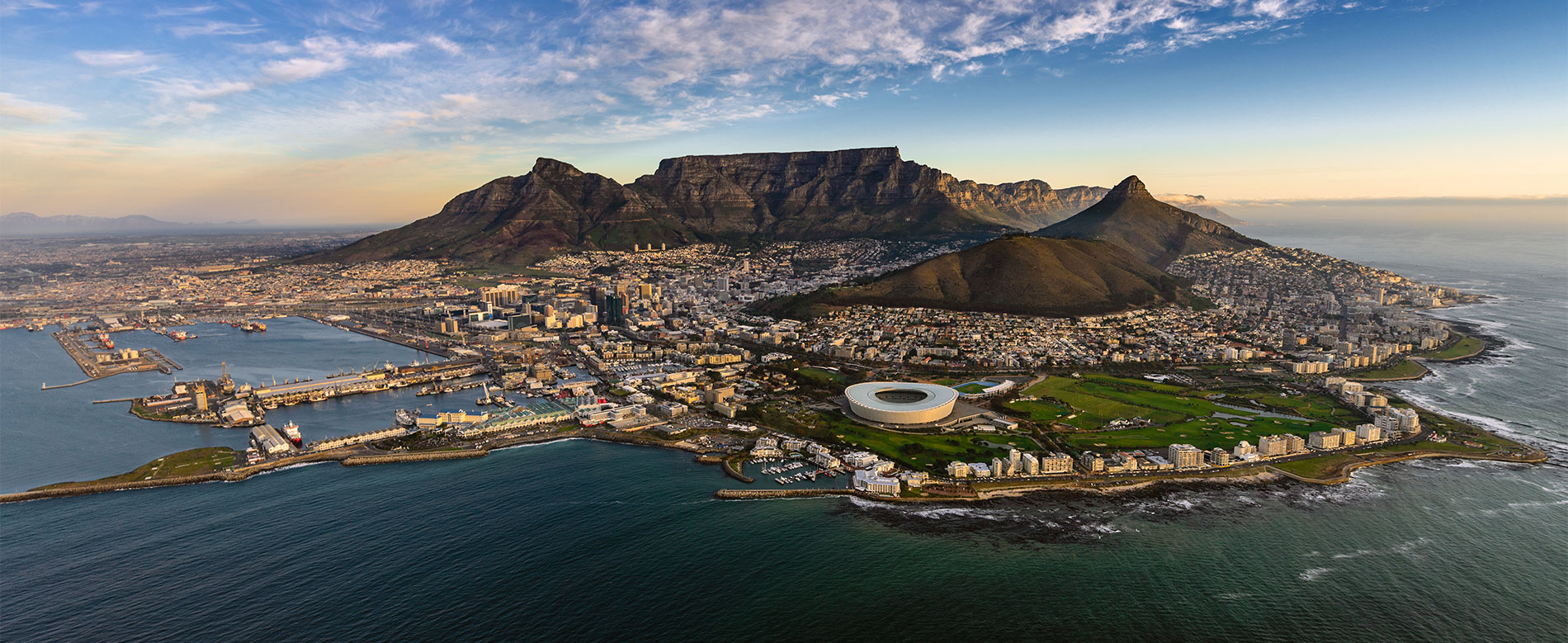 an image of table mountain surrounded by the ocean